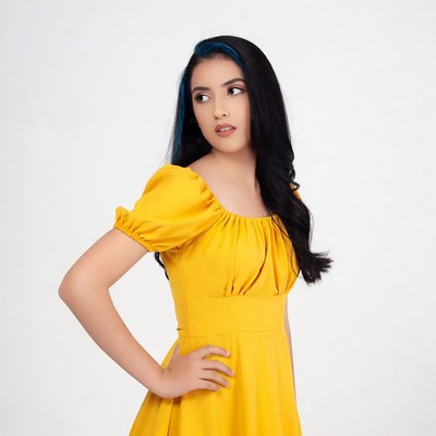 Young woman in yellow dress poses