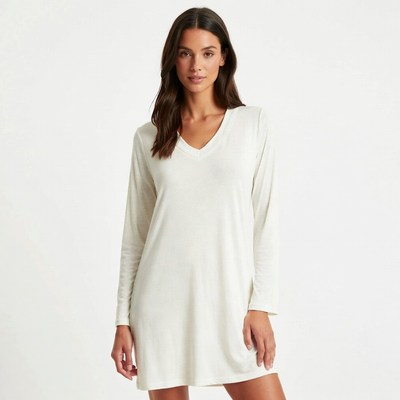 Model in light dress poses indoors