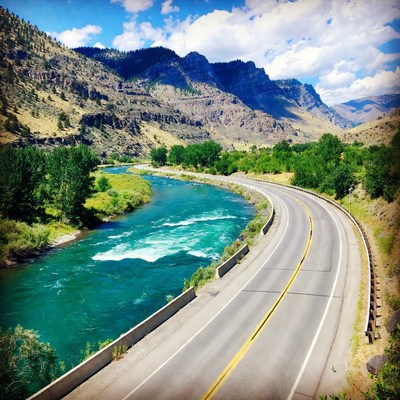 River flows next to winding road