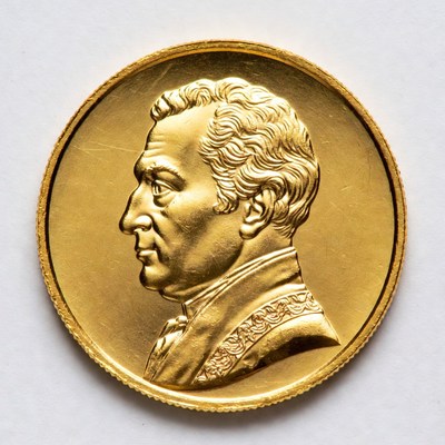 Gold coin with historical figure profile