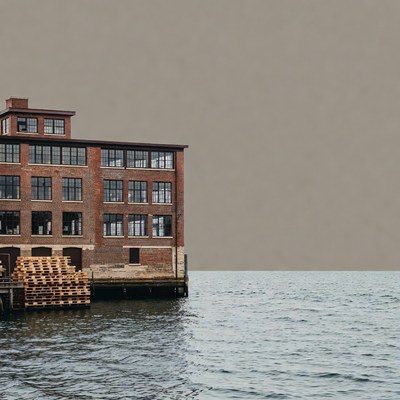 Building by the water at sunset