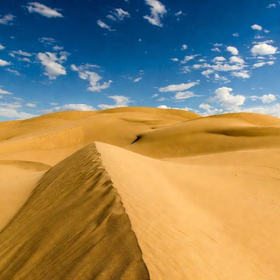 Sand dunes under blue sky