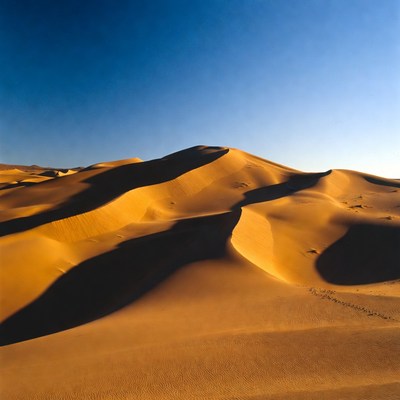 Sand dunes under clear sky