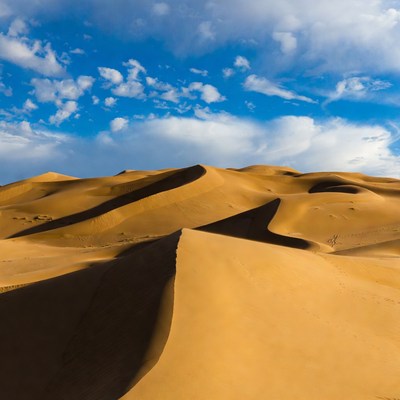 Sand dunes under blue sky