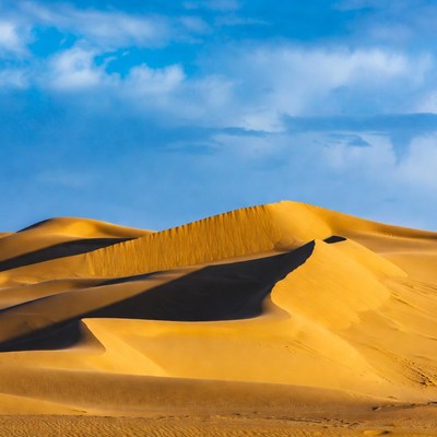 Sand dunes under blue sky