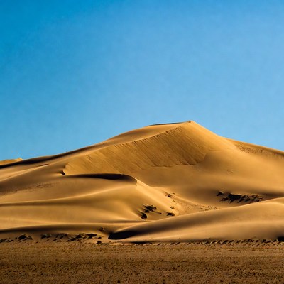 Sand dune landscape under blue sky