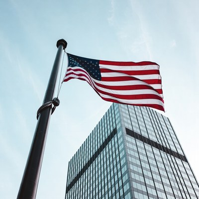 Flag waving beside tall building