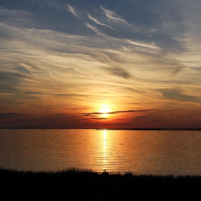 Sunset over calm water landscape