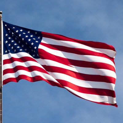 Waving flag against blue sky