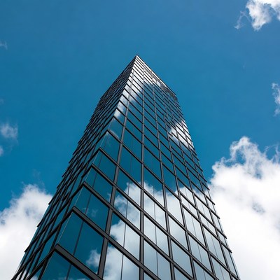 Modern building with glass facade reaching sky