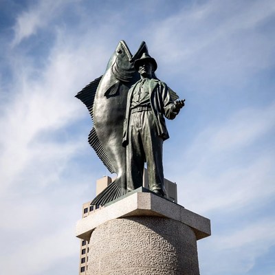 Fisherman statue near waterfront area