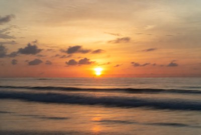 Sunset over the ocean waves