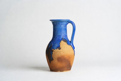 Clay pitcher with blue design
