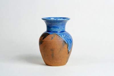 Handcrafted clay vase with blue glaze