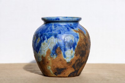 Blue and brown ceramic pot on display