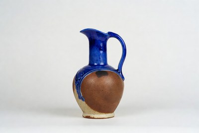 Clay pitcher with blue handle design