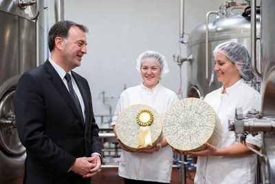 Cheese makers show awards to visitor