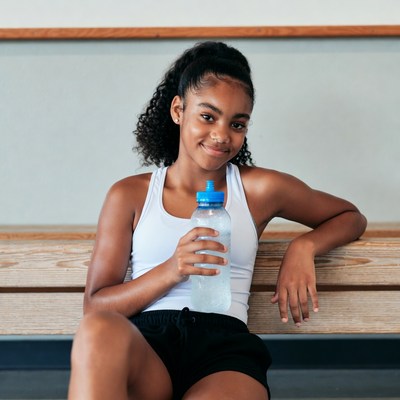 Girl holding water bottle after workout
