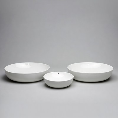 White ceramic bowls arranged in a line