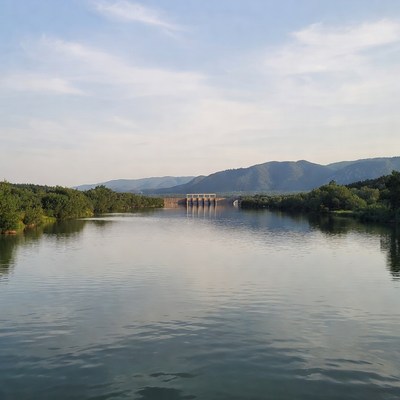 View of calm river and bridge at sunset