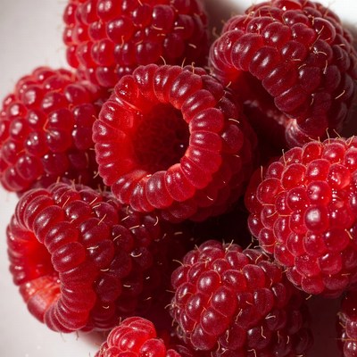 Fresh raspberries on a white plate