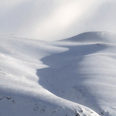Snowy landscape with shadows at midday