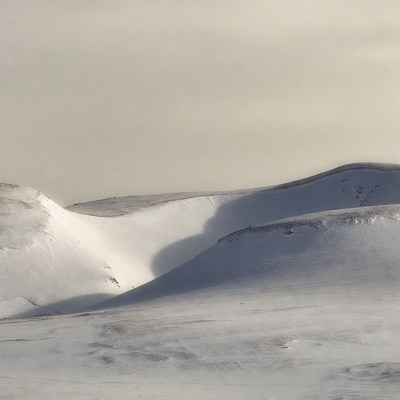 Snow-covered hills in winter light