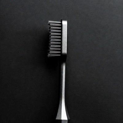 Metal brush on black surface
