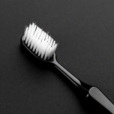 Black and white toothbrush on surface