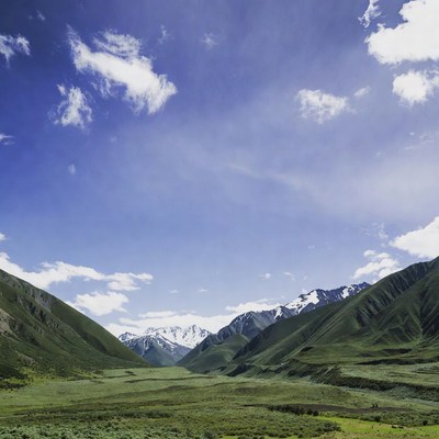 Mountains and valley under blue sky