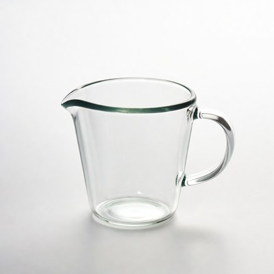 Clear glass measuring cup on a table