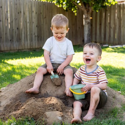 Children playing in dirt pile outdoors