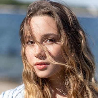 Girl with wavy hair by the sea