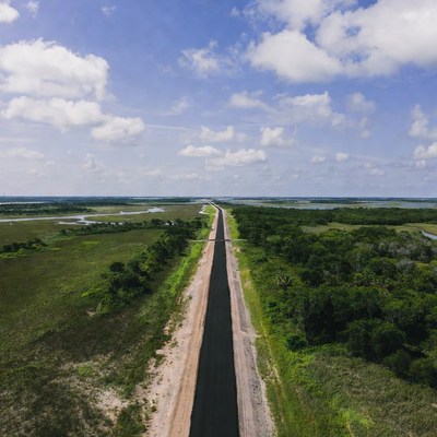 Long road through green landscape