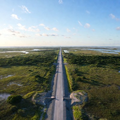 Road stretches through green landscape
