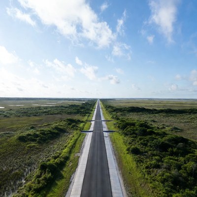 Road stretching through green landscape