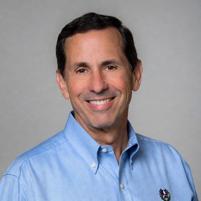 Smiling man in blue shirt indoors