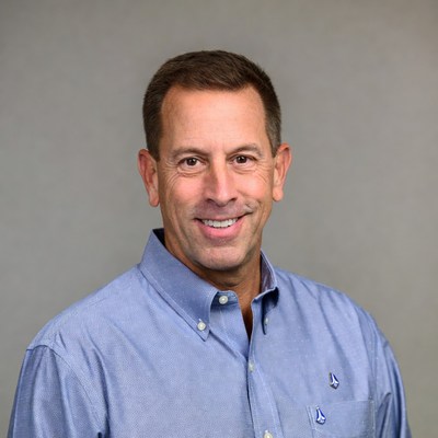 Man smiles in professional setting