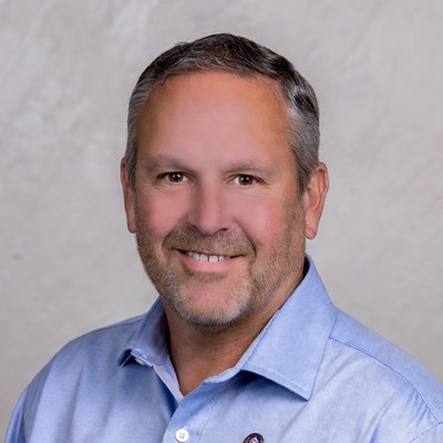 Man smiles in a bright office