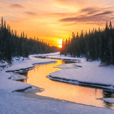 Winter sunset over frozen river