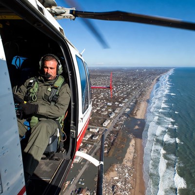 Helicopter pilot flying over coastline