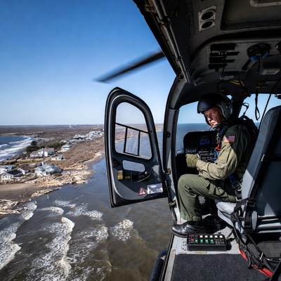 Helicopter pilot flying over shoreline