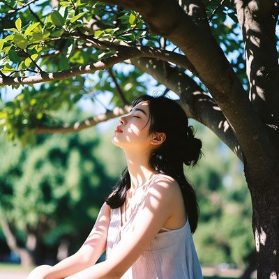 Woman relaxing under tree shade