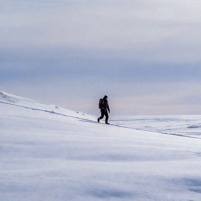 Person walking on snowfield in winter