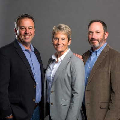 Group of three people posing indoors