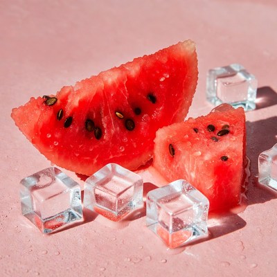 Fresh watermelon and ice cubes on pink