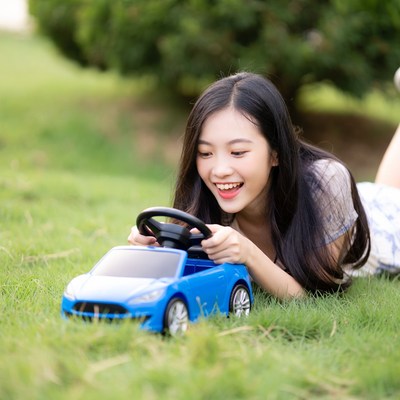 Child plays with toy car outdoors