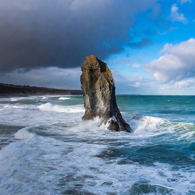 Waves crash against a rocky shore