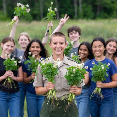 Group of students gardening outside together