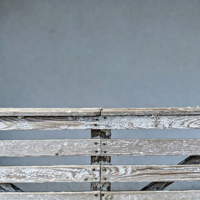 Wooden fence against gray wall